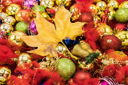 Christmas vibrant colorful wallpaper background texture of balls and decorations for the celebration tree and dry leafs.の写真素材