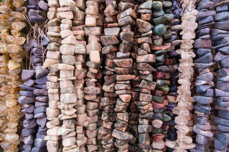 Wallpaper background of colorful necklace made of gemstones and colored beads showcased in a shop. Semi precious jewelery.の写真素材