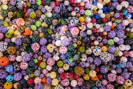 Beautiful wallpaper background of colorful jewelery beads of many shapes and materials.の写真素材