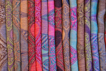 Wallpaper background of colorful upholstery fabric texture in a store. Multiple patterns and colors. No people.の写真素材