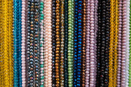 Wallpaper background of colorful necklace made of gemstones and colored beads showcased in a shop....