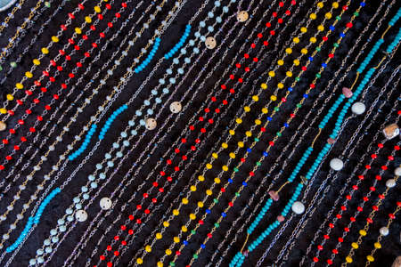 Wallpaper background of colorful necklace made of gemstones and colored beads showcased in a shop. Semi precious jewellery.の写真素材