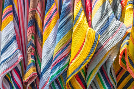 Wallpaper background of colorful woman dresses on hangers. No people.の写真素材