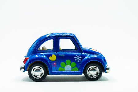 Side view of blue vintage car toy with colorful flowers paintの写真素材