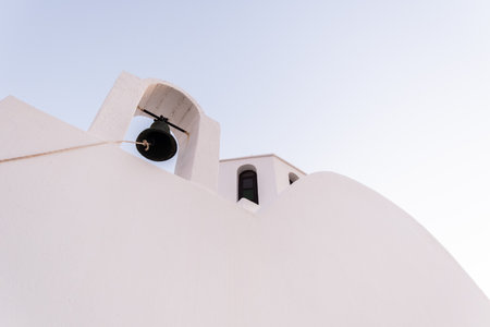 White wall with bell of a church in Santoriniの写真素材