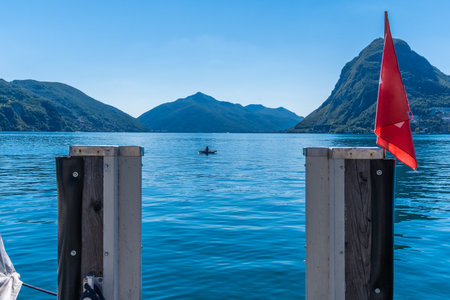 Boats of Lugano with a swiss flag. Switzerland. Canton Ticinoの写真素材