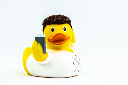 Narcissist Duck Floating Toy with cel phoneの写真素材