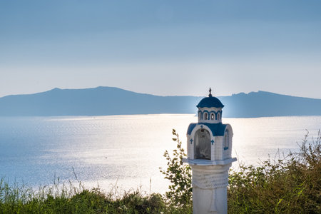 Small white and blue tower with the sea in the backgroundの写真素材