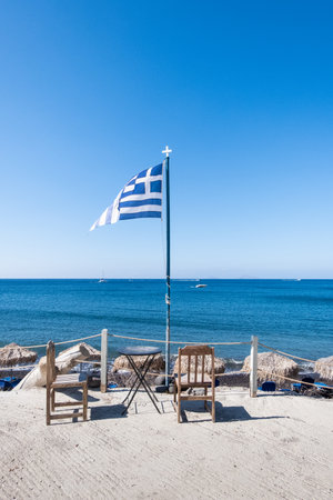 Greek flag and blue sky at a dock at Santorini island, Greeceの写真素材