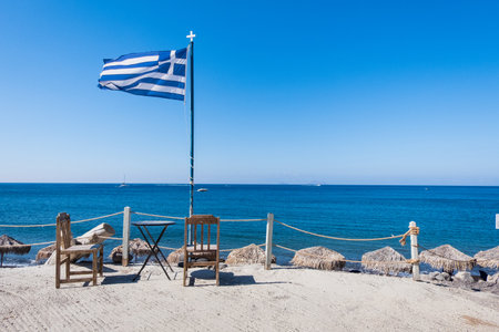 Greek flag and blue sky at a dock at Santorini island, Greeceの写真素材