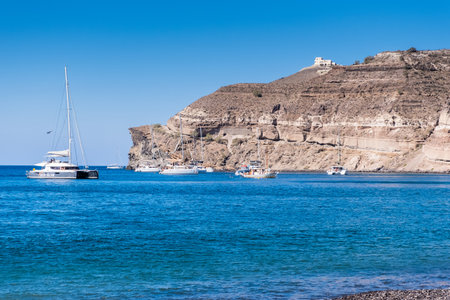 Boat on the aegean sea near Santorini island shoreの写真素材