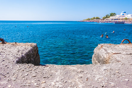 Concrete jetty stretches into the Aegean Sea from the coast of Santoriniの写真素材