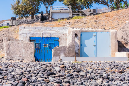 Blue doors of a stone building on the beach of Santorini island, Greeceの写真素材