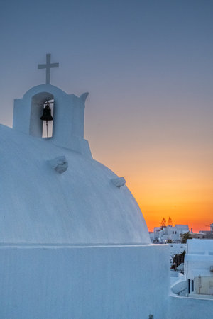 Beautiful sunset over white church of Oia, Santorni, Greeceの写真素材