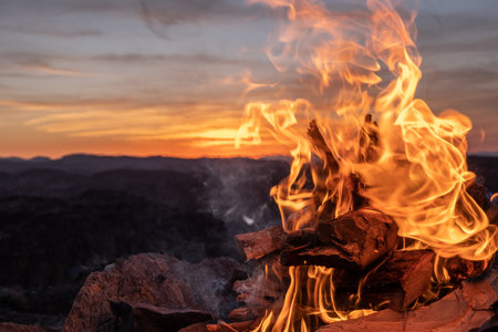 Burning fire hearth on a rocky mountain peak in the middle of the sahara desertの写真素材