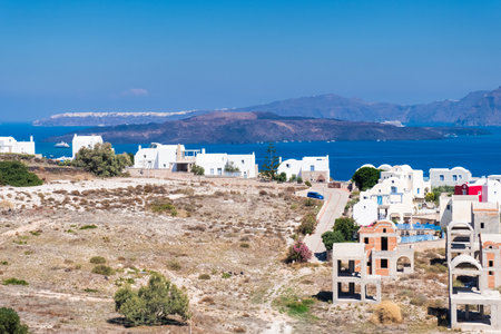 View of the archipelago and island of Santorini in Greece with houses under construction.の写真素材