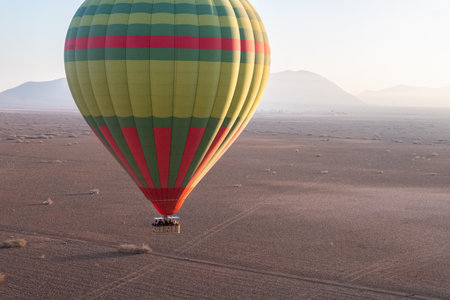 Aerial view of a hot air balloon flying over the desert near Marrakech in Moroccoの写真素材
