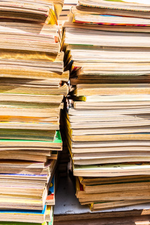 A column of old books with the pages yellowed by time stacked on top of each otherの写真素材