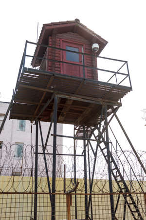 Prison tower and barbed wire fenceの写真素材