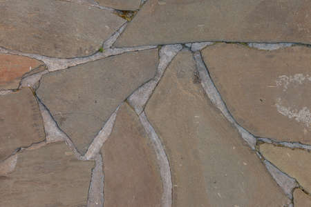 Textured stone background with cement elements. Fragment of wall or sidewalk made of rubble. Design...