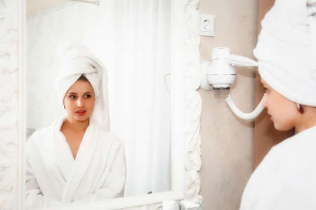 Girl of Slavic appearance in bar, cafe or restaurant with white Cup. Female shows emotion. Young...