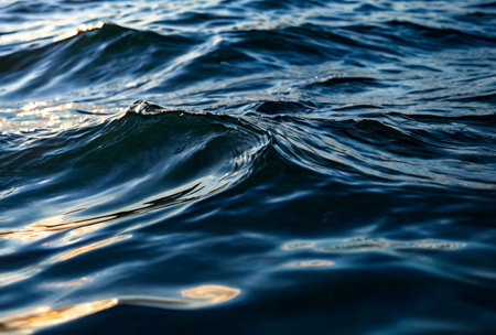 Wave pattern surface fresh or sea reservoir. Wallpaper background of lapping river waves on water surface sea or ocean waves. Backgrounds nature wallpapers concept. Photo ripples lake. Copy spaceの素材