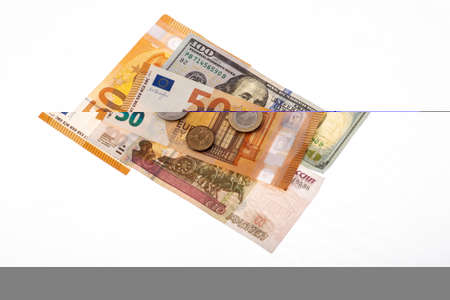 Dollars, euros, rubles and pounds lie on the surfaceの写真素材