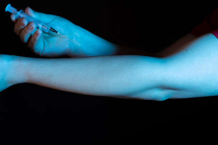 the man in the blue light pricks himself