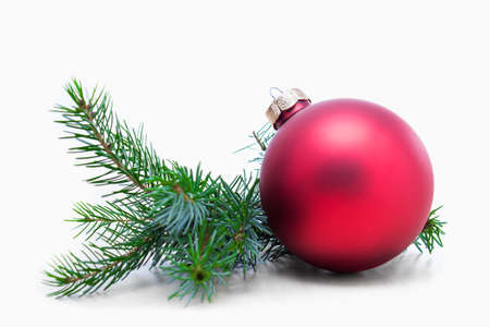 Christmas ball and green spruce branch, isolated white backgroundの写真素材