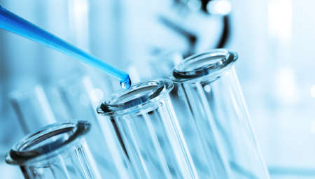 pipette and test tube on blue backgroundの写真素材