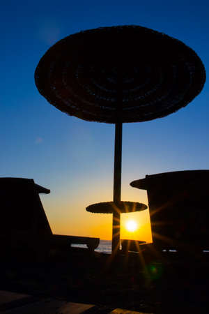 Beach umbrella on the beach at sunsetの写真素材