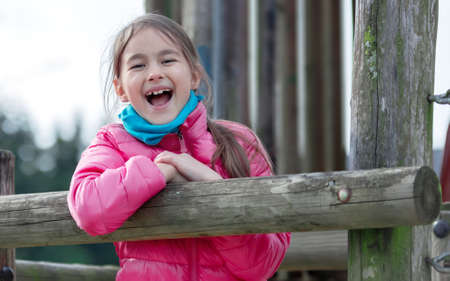 beautiful smiling cute girl on a playgroundの写真素材