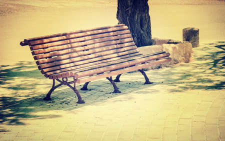 Antique metal bench on the park. vintage color toned image の写真素材