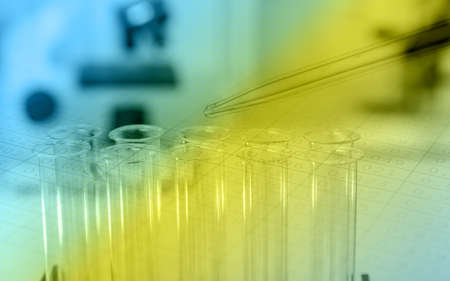 Pipette adding fluid to one of several test tubes .medical glasswareの写真素材