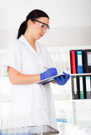 female doctor is writing prescription at the clinicの写真素材