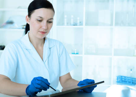 female doctor is writing prescription at the clinic