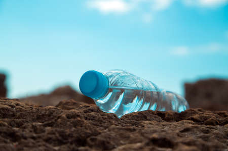 pet bottle with water on the sea sand.の写真素材