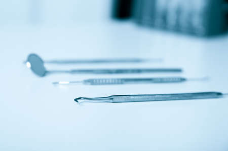 Dental tools and equipment over blue .Set of metal medical equipment tools for teeth dental careの写真素材