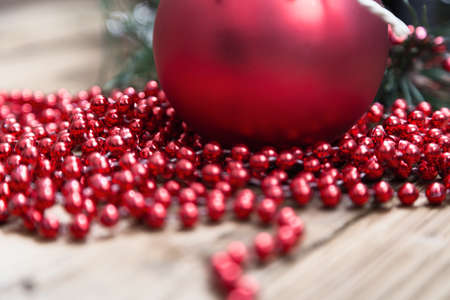 Christmas balls and spruce twigs on wooden backgroundの写真素材