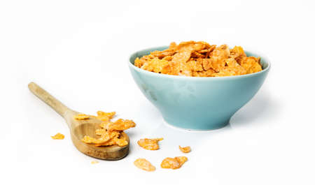 Oat flakes in bowl and wooden spoon on white background...の写真素材