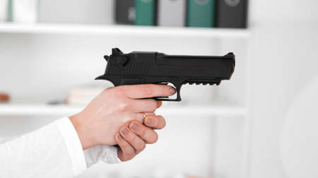 Beautiful woman aiming gun.