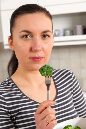 happy woman eating a healthy vegetarian food vegetable saladの写真素材