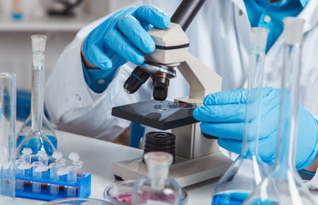 Female Scientist Analyzing Sample In Laboratory.laboratory assistant analyzing a sample