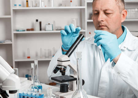 male scientific researcher using microscope in the laboratory.の写真素材