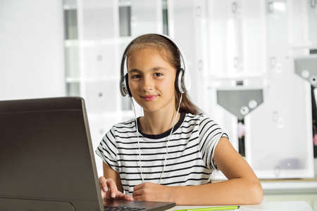 Beautiful girl working on her school project at home..