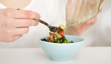 Quinoa salad with fresh tomatoes, cucumbers and salad leavesの写真素材
