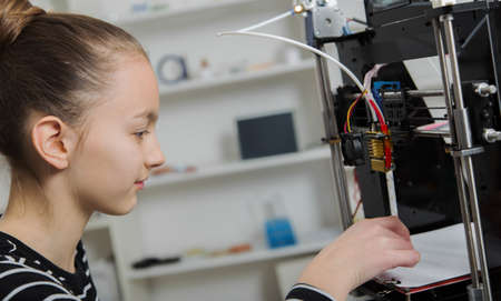 kid with 3d printe. education, technology,