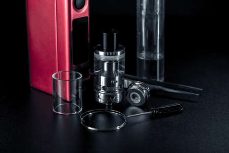 vape e liquid and vaping device for electronic cigarette on a dark background