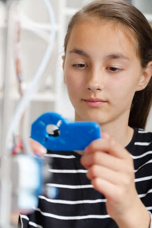 schoolgirl with 3d printe. education, technology.