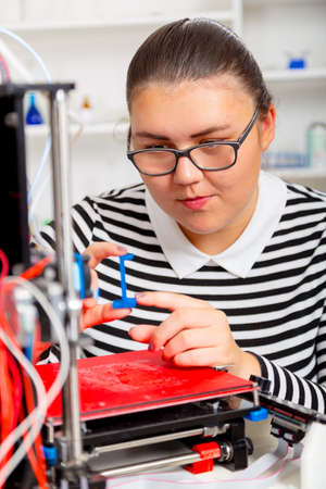 Schoolgirl with 3d printe. education